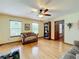 Living room with hardwood floors, built-in shelving, and a ceiling fan at 4155 Quail Wood Dr, St Cloud, FL 34772