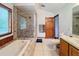 Clean bathroom with a shower, tub, and wood cabinets at 4155 Quail Wood Dr, St Cloud, FL 34772