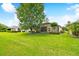Large backyard with green grass and partial home view at 196 Ventana Dr, Poinciana, FL 34759