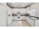 Bright eat-in kitchen with white cabinetry, modern appliances, and tile flooring at 196 Ventana Dr, Poinciana, FL 34759