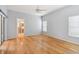Large bedroom with hardwood floors, neutral walls, and access to bathroom at 196 Ventana Dr, Poinciana, FL 34759