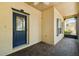 Bright screened porch with brick floor, ceiling fan, and blue door at 196 Ventana Dr, Poinciana, FL 34759