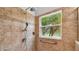 Bathroom with walk-in shower, grab bar, and window for natural light at 196 Ventana Dr, Poinciana, FL 34759