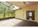Screened patio overlooking backyard and trees at 196 Ventana Dr, Poinciana, FL 34759