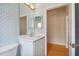 Bathroom with vanity, light blue wallpaper and mirror at 196 Ventana Dr, Poinciana, FL 34759