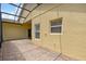 Covered patio with pavers and a screened enclosure at 196 Ventana Dr, Poinciana, FL 34759