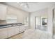 Kitchen with white cabinets, tile floors, and sliding door to patio at 196 Ventana Dr, Poinciana, FL 34759