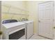 Laundry room with washer, dryer, and wire shelving at 196 Ventana Dr, Poinciana, FL 34759