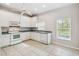 Kitchen with white cabinets, tile floors, and stainless steel appliances at 196 Ventana Dr, Poinciana, FL 34759