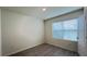 Simple bedroom with a large window and gray vinyl flooring at 1286 Iguana Loop, Davenport, FL 33897