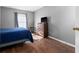 Bedroom with dark wood floors, blue bedding, and a dresser at 2090 Big Buck Dr, St Cloud, FL 34772