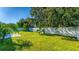 Spacious backyard with grassy lawn, white fence, and patio at 2090 Big Buck Dr, St Cloud, FL 34772