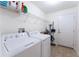Laundry room with washer, dryer, and storage shelves at 2090 Big Buck Dr, St Cloud, FL 34772