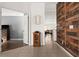 Bright entryway with wood-look accent wall, and view of living area at 2090 Big Buck Dr, St Cloud, FL 34772
