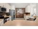 Updated kitchen featuring stainless steel appliances and wood-look accent wall at 2090 Big Buck Dr, St Cloud, FL 34772