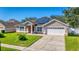 House exterior with solar panels and driveway at 2090 Big Buck Dr, St Cloud, FL 34772