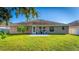 Home's back exterior boasts a patio and grassy yard at 2090 Big Buck Dr, St Cloud, FL 34772