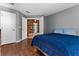 Bedroom with wood-look floors and blue bedding, offering access to another room at 2090 Big Buck Dr, St Cloud, FL 34772