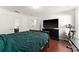 Bedroom with a queen-size bed, exercise bike, and wood floors at 2090 Big Buck Dr, St Cloud, FL 34772