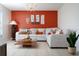 Living area with sectional sofa, accent wall, and stylish decor at 2090 Big Buck Dr, St Cloud, FL 34772