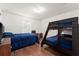 Bedroom with a full-size bed, bunk bed, and wood floors at 2090 Big Buck Dr, St Cloud, FL 34772