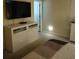 Bright bedroom featuring a large TV, dresser, and comfortable bedding at 13155 Kegan St, Windermere, FL 34786