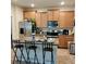 Spacious kitchen boasts an island, stainless steel appliances, and wood cabinets at 13155 Kegan St, Windermere, FL 34786