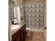 Neat bathroom with a single sink, shower/tub combo, and updated fixtures at 13155 Kegan St, Windermere, FL 34786