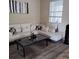 Living room with white sectional sofa and contemporary coffee table at 13155 Kegan St, Windermere, FL 34786
