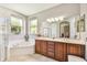 Elegant bathroom with double vanity and corner soaking tub at 350 Balboa Dr, Kissimmee, FL 34759