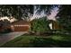 Well-lit front yard with palm tree and brick driveway at 350 Balboa Dr, Kissimmee, FL 34759