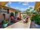Relaxing patio with brick flooring, comfortable seating, and lush landscaping at 350 Balboa Dr, Kissimmee, FL 34759