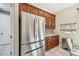 Stainless steel refrigerator in kitchen with wood cabinets at 350 Balboa Dr, Kissimmee, FL 34759