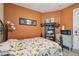 Cozy bedroom with a double bed and an orange wall at 350 Balboa Dr, Kissimmee, FL 34759