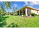 Private backyard with green grass and screened porch at 350 Balboa Dr, Kissimmee, FL 34759