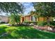 Landscaped front yard with mature trees and well-manicured lawn at 350 Balboa Dr, Kissimmee, FL 34759