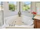 Relaxing bathroom featuring a corner bathtub and shower at 350 Balboa Dr, Kissimmee, FL 34759