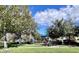 Community playground with shaded seating, play equipment and picnic tables at 3040 Palermo Rose Way, Kissimmee, FL 34746