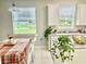 Bright kitchen with white cabinets, a breakfast nook, and a view of a pond at 3040 Palermo Rose Way, Kissimmee, FL 34746