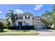 Two story house with a two car garage and manicured lawn at 3040 Palermo Rose Way, Kissimmee, FL 34746