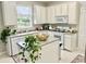 Kitchen with island, white cabinets, and granite countertops at 3040 Palermo Rose Way, Kissimmee, FL 34746
