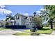Two story house with a two car garage and manicured lawn at 3040 Palermo Rose Way, Kissimmee, FL 34746