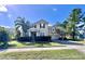 Two story house with a large yard and a two-car garage at 3040 Palermo Rose Way, Kissimmee, FL 34746