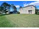 Large backyard with a view of neighboring house and lush green grass at 3040 Palermo Rose Way, Kissimmee, FL 34746