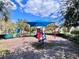 Community playground with shaded seating and play equipment for  at 3040 Palermo Rose Way, Kissimmee, FL 34746