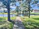 Peaceful pond with a walking path and benches, perfect for relaxing at 3040 Palermo Rose Way, Kissimmee, FL 34746