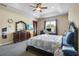 Large main bedroom with carpeted floors, ceiling fan, and a workspace at 3146 Lake Jean Dr, Orlando, FL 32817