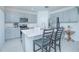 Modern kitchen island with gray cabinets and stainless steel appliances at 570 Pink Ibis Bnd, Saint Cloud, FL 34772