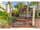 Relaxing gazebo with wooden deck, outdoor shower, and lush landscaping at 8818 Dunes Ct # 306, Kissimmee, FL 34747