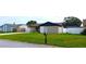 Tan home with a black roof and well-maintained lawn at 449 Ball Ct, Kissimmee, FL 34759